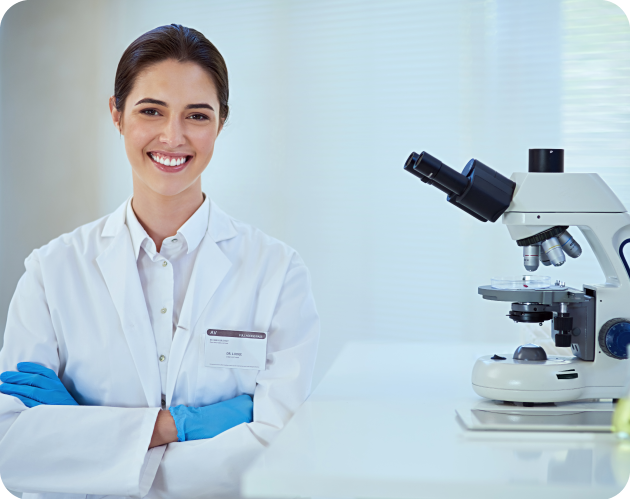 Doctor smiling with a microscope on the side